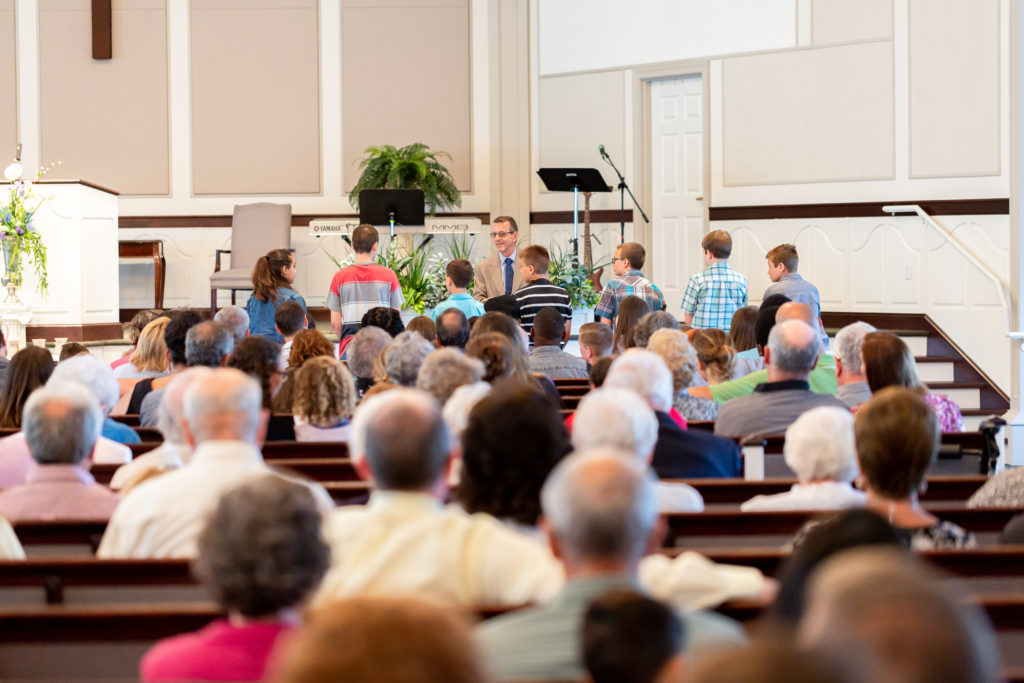 Looking toward pulpit in church filled with people